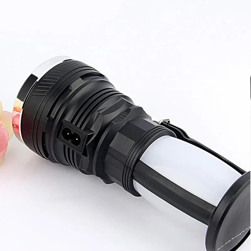 Black solar-powered rechargeable LED torch with USB charging port.