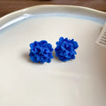 Geometric women's earrings with cloth construction, silver needle and blue resin flower accents