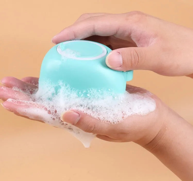 Blue silicone dog bath brush with finger grip handle for washing and massaging