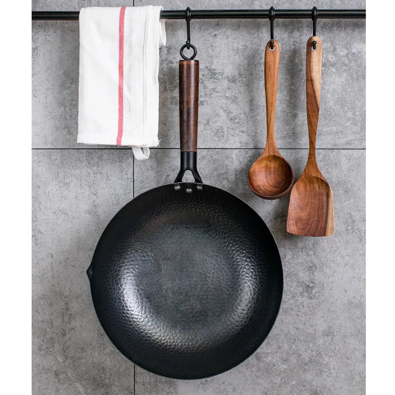 Black traditional iron wok with wooden handle measuring 40cm diameter
