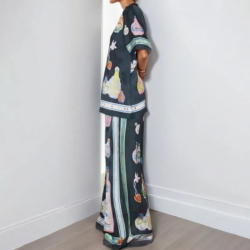 Black women's cardigan set with cartoon pattern, includes top with regular sleeves and matching trousers