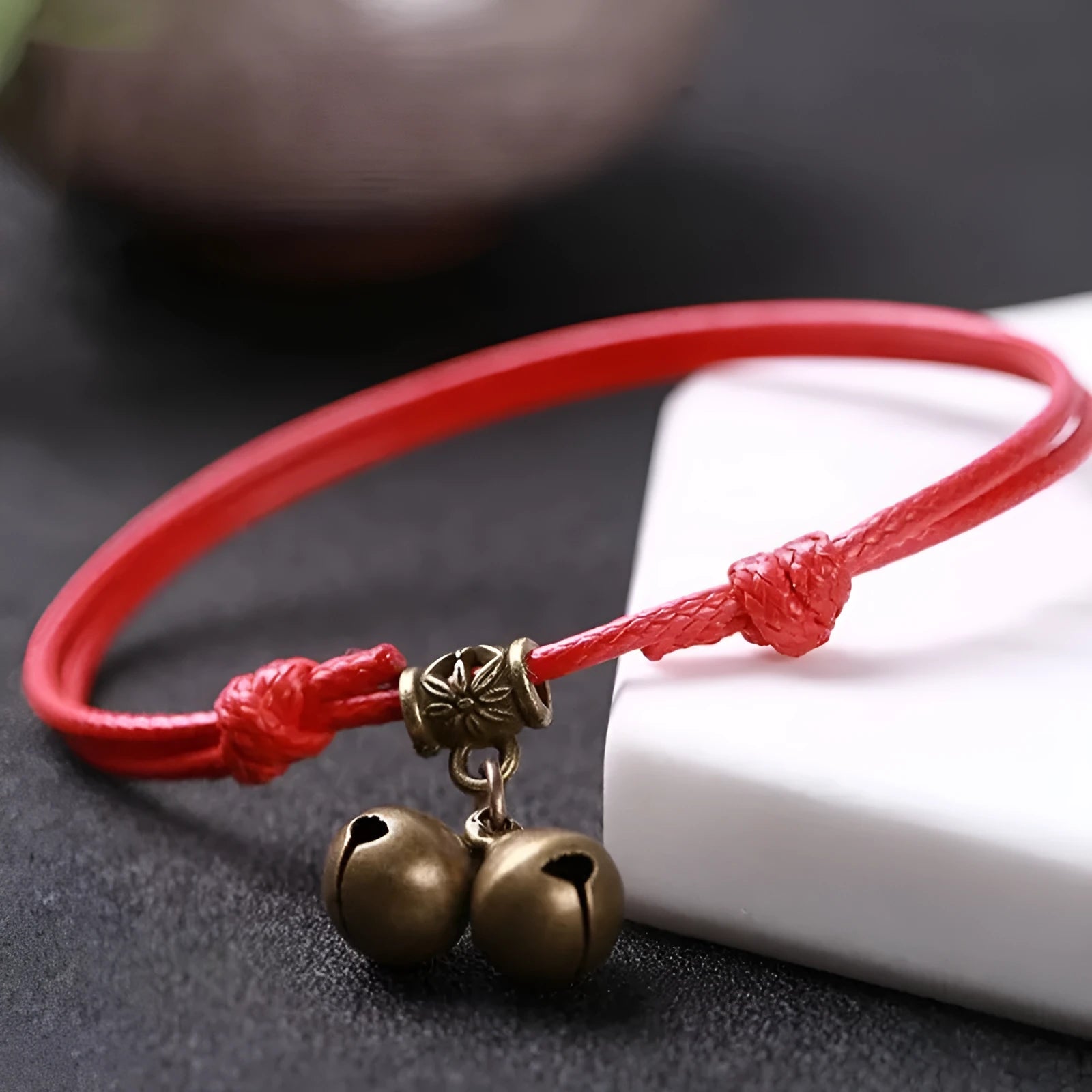 Adjustable nylon rope dog collar with brass bell shown in black, red, and coffee colours.