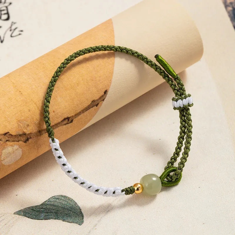 Women's Chinese national bracelet with Hetian jade charm on cord carrying strap