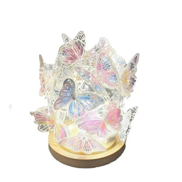 Handmade butterfly-shaped night lamp with glass shade on a raw wood base.