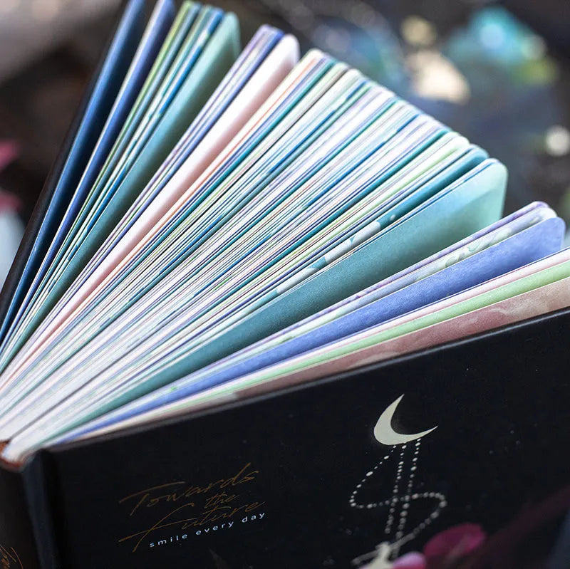 A5 notebook with luminous cover open to show an internal colour illustration, in deep blue colour.