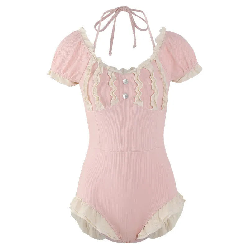 Pink women's one-piece swimsuit with conservative coverage and Siamese design details