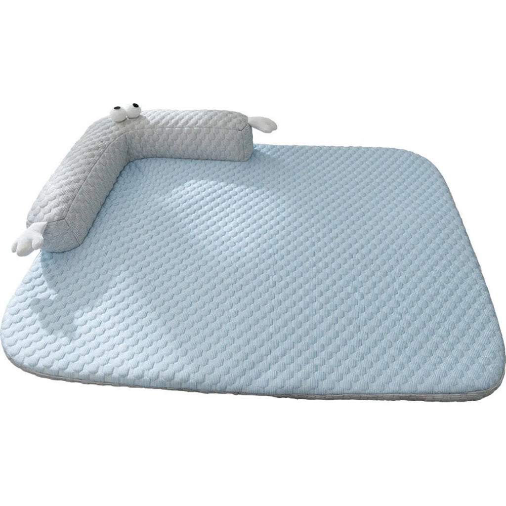 Blue pet cooling mat with big-eyed monster print on a wooden floor