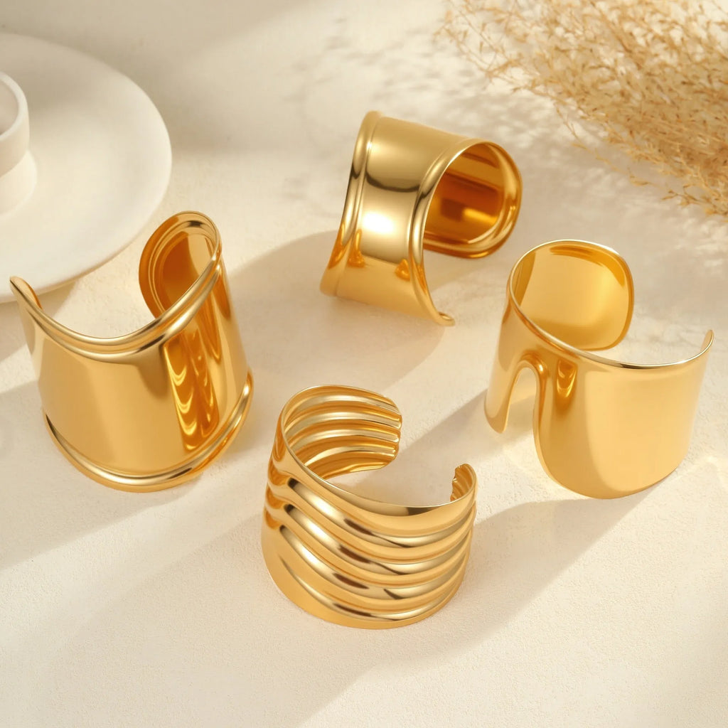 Women's wide stainless steel bracelet with gold plating and wave geometric pattern