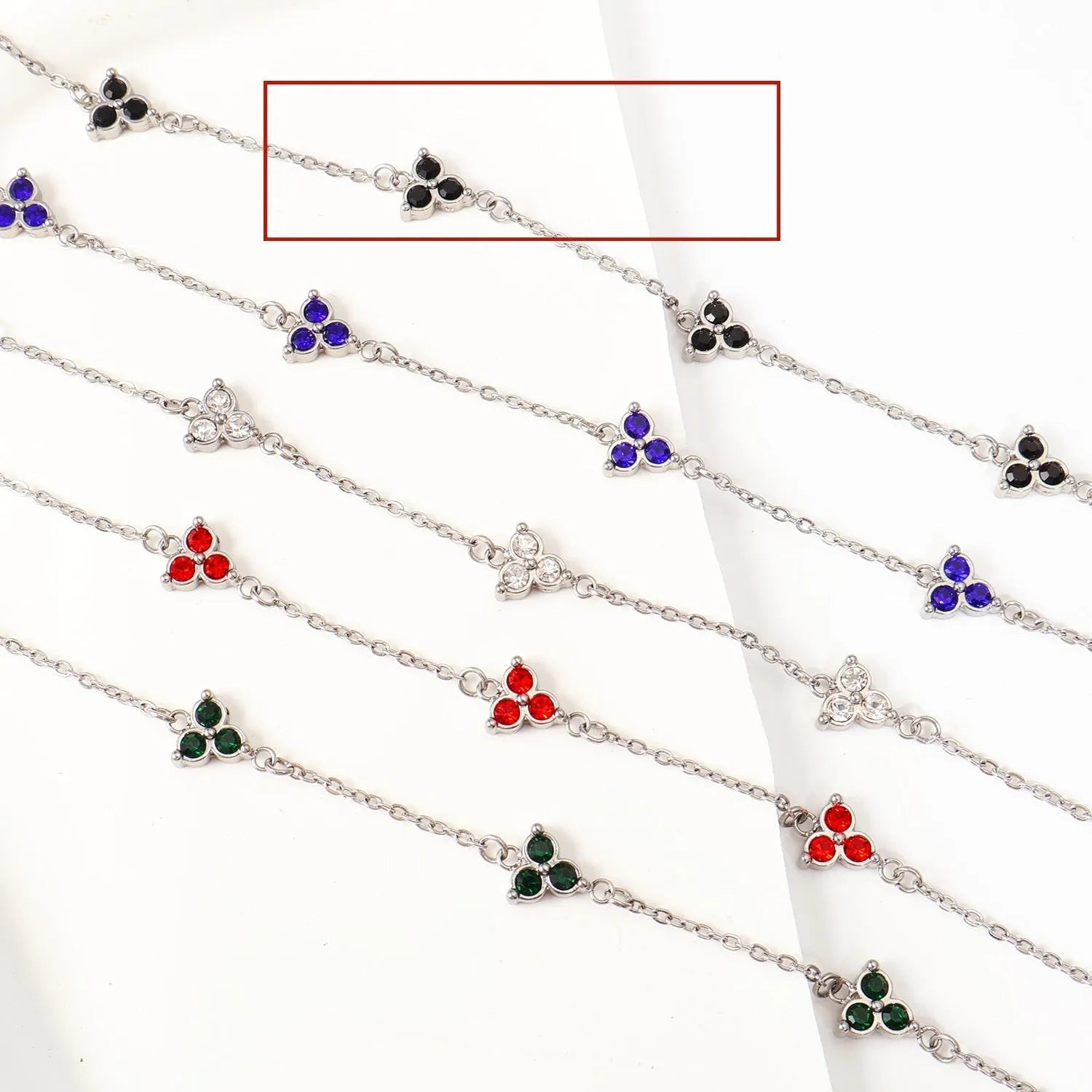 Stainless steel women's bracelet with three geometric diamond charms and zircon gemstones