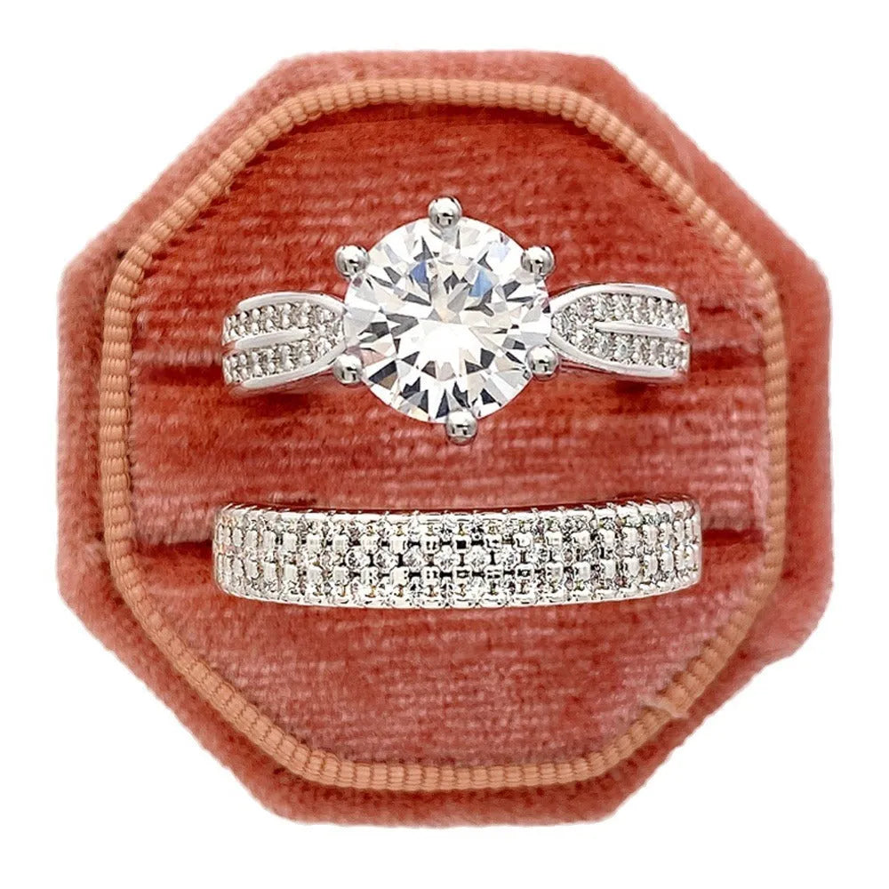 White gold colour geometric alloy wedding ring on a finger, showing its simple round band design.