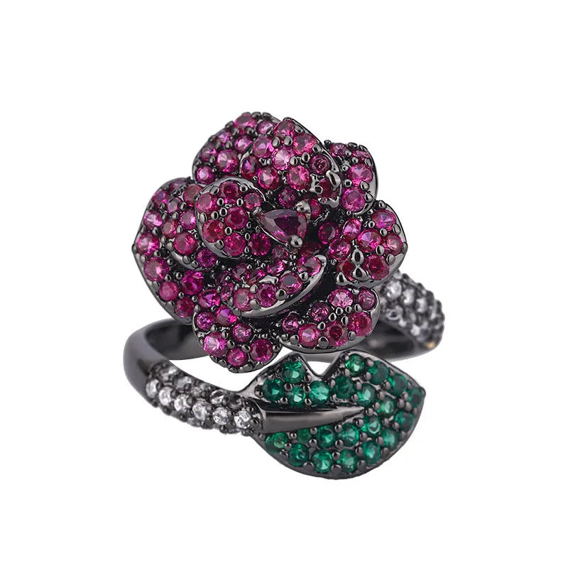 Gold-plated geometric flower ring with red simulated corundum stone on black gold finish