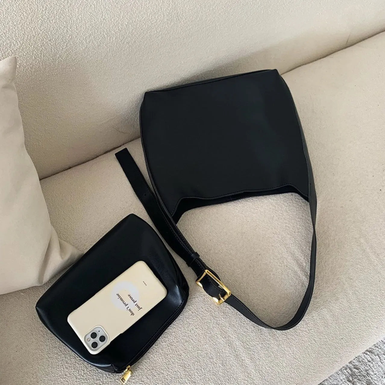 Two women's fashion shoulder bags: black with ribbon and brown with packet designs showing swing thread details