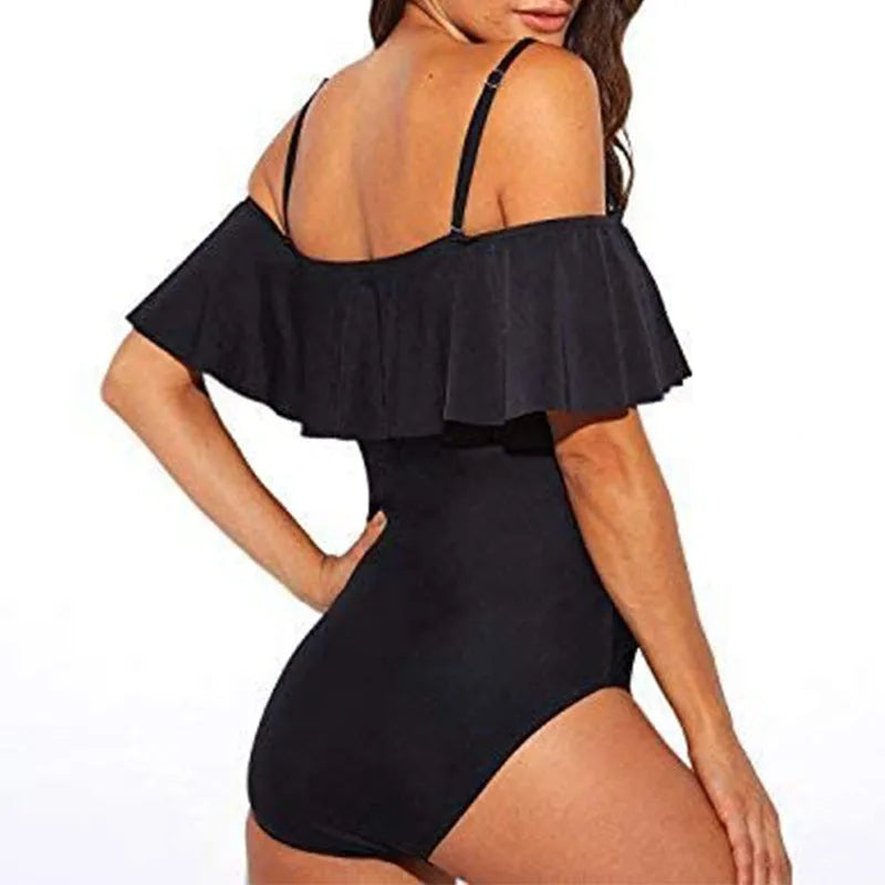 Black one-piece swimsuit with ruffled cut-out tube top design on a mannequin.