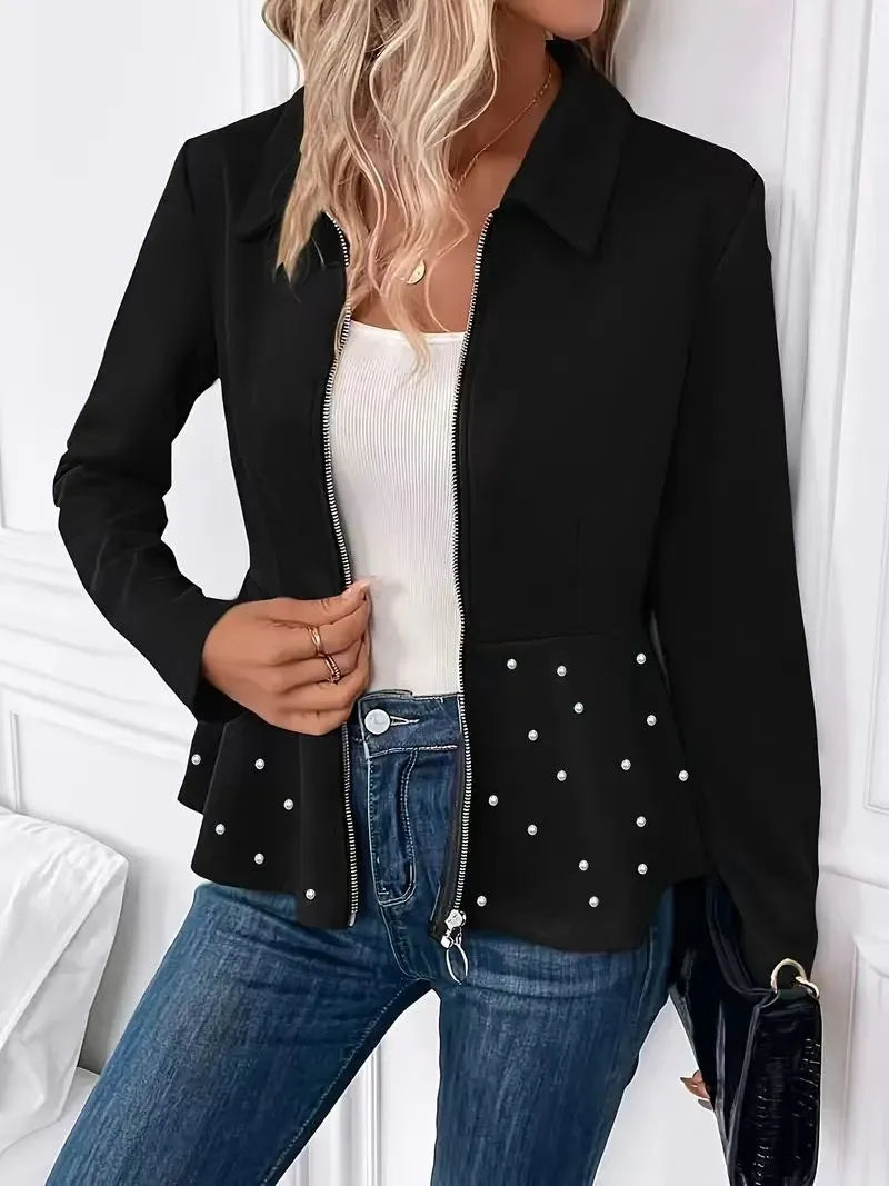 Women's black loose-fit coat with heavy-duty zipper front and ruffled hem detail.