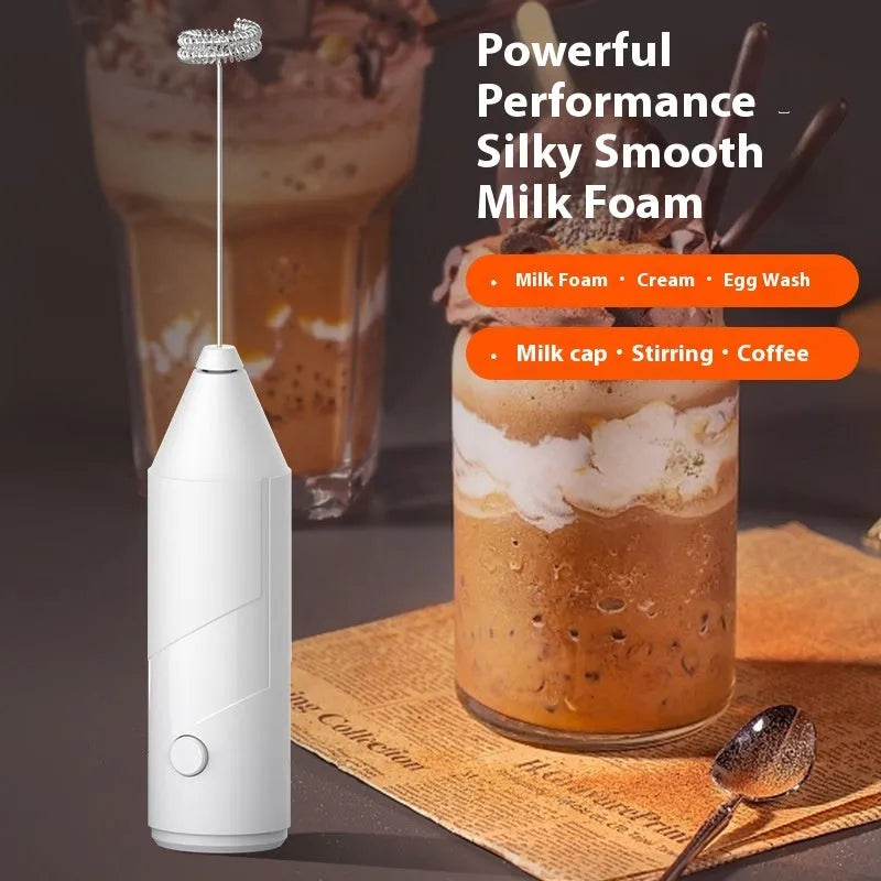 Mini handheld electric milk frother in black colour with stainless steel whisk and USB charging port.
