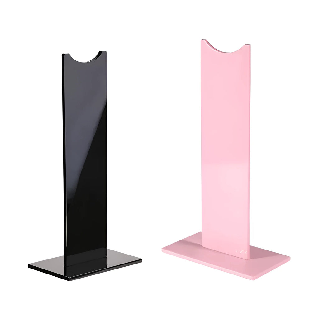 Pink and black detachable head-mounted gaming headset bracket on a desk