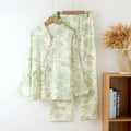 Women's pink cotton gauze long sleeve top and trousers lounge suit set on a hanger.