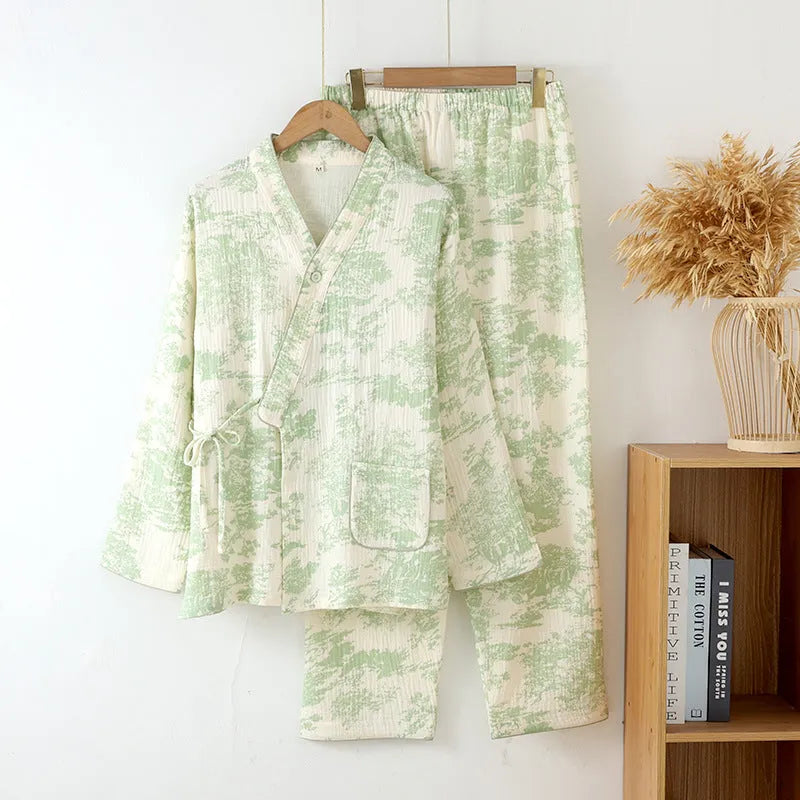 Women's pink cotton gauze long sleeve top and trousers lounge suit set on a hanger.