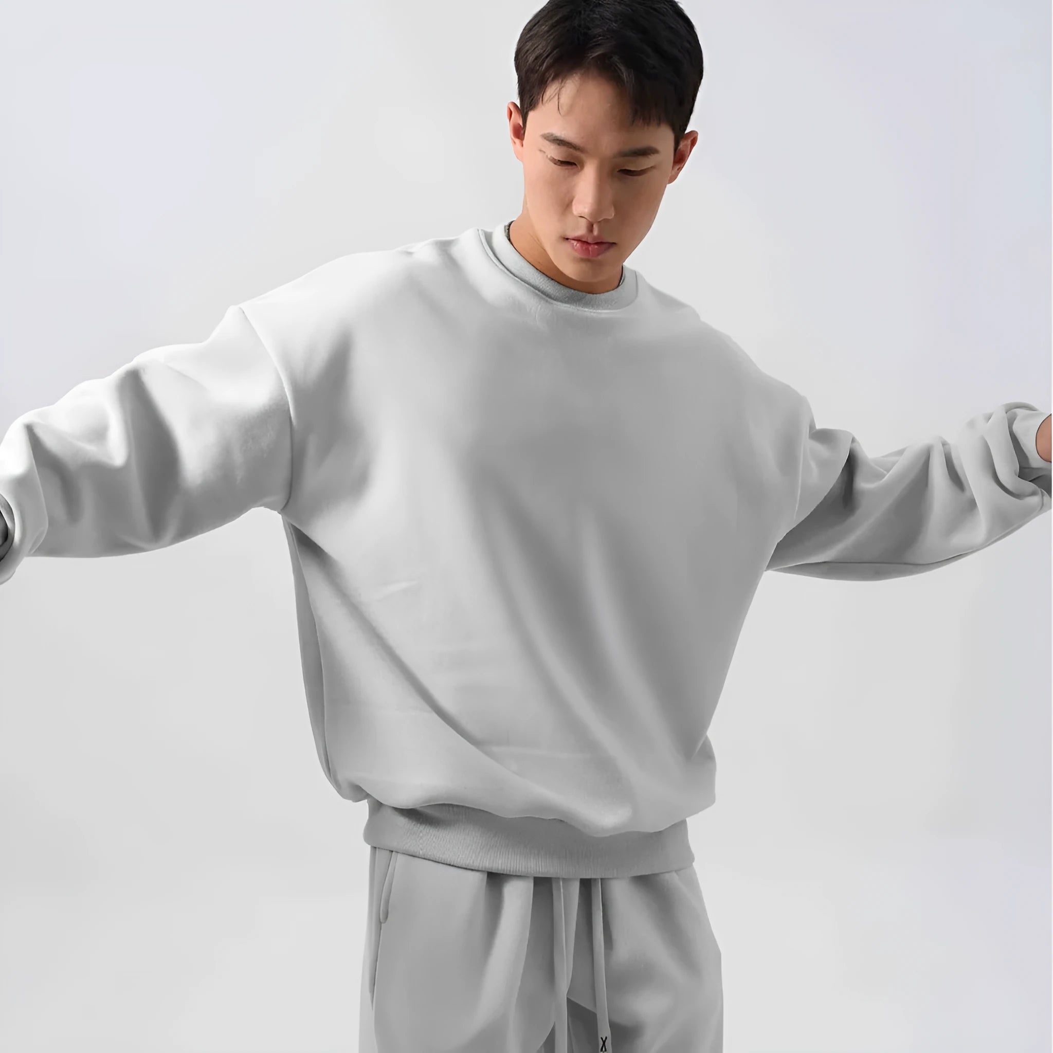 Men's black polar fleece sports suit with long sleeve crew neck coat and loose fit trousers.