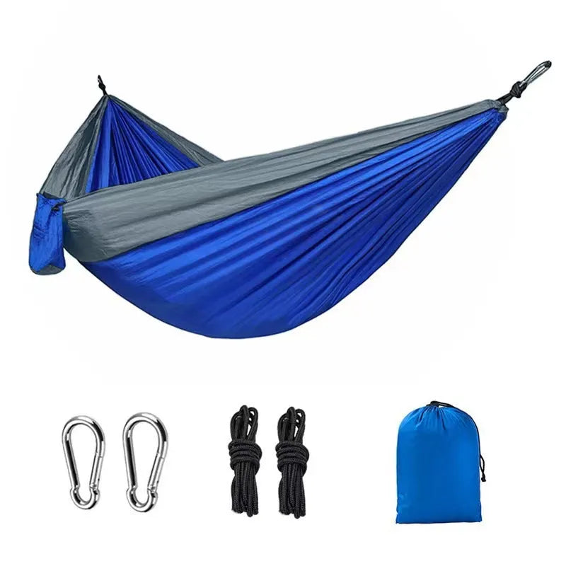 Blue nylon parachute cloth outdoor hammock hanging between trees