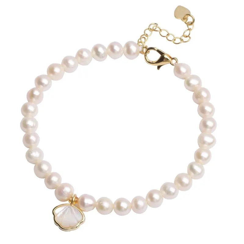 Women's freshwater pearl bracelet with fan-shaped arrangement of 5-6 near round pearls on 16cm band