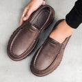 Men's black leather slip-on shoe with a mid-top design and platform sole