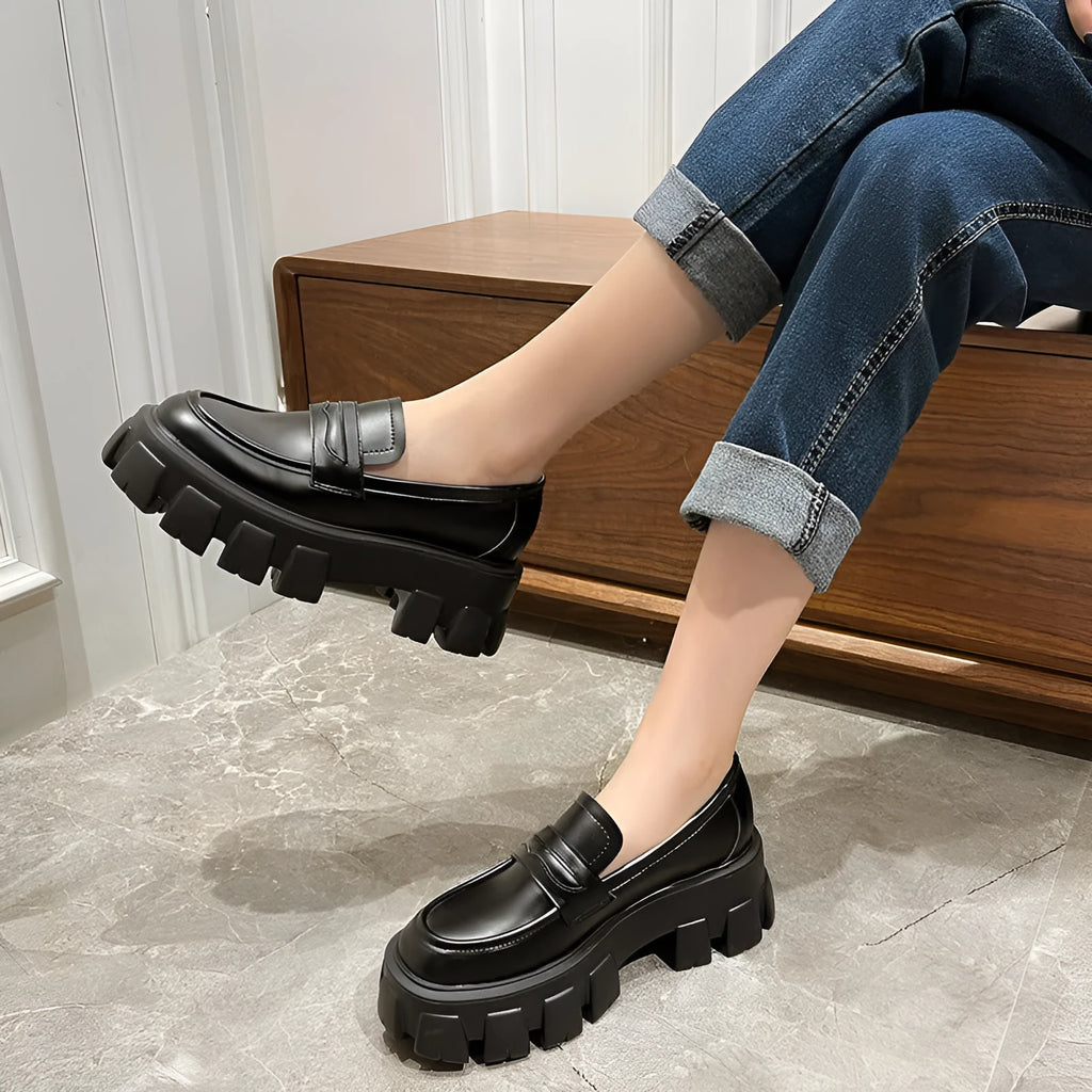 A pair of British style wide fit loafers with a shallow opening, shown in a choice of matte or glossy patent leather.