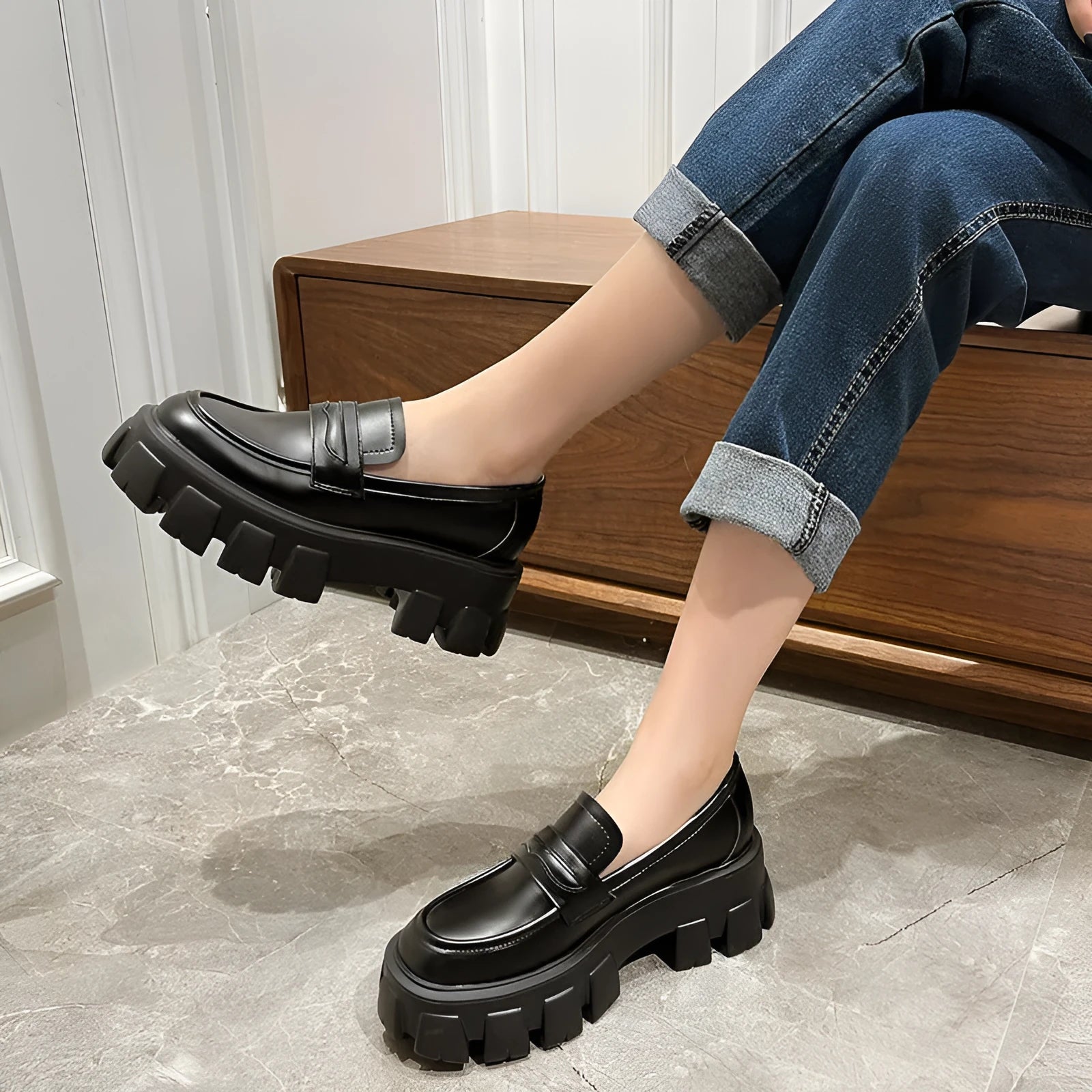 A pair of British style wide fit loafers with a shallow opening, shown in a choice of matte or glossy patent leather.