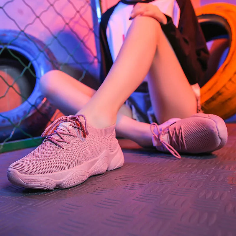Women's white thick-soled sports shoes with flying woven upper and front strap.