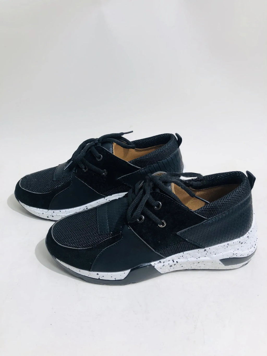 Women's casual flat sneakers in leopard print with suede upper and a low wedge heel.