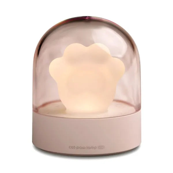 Pink cat paw shaped USB rechargeable night light with musical box function on wooden desktop