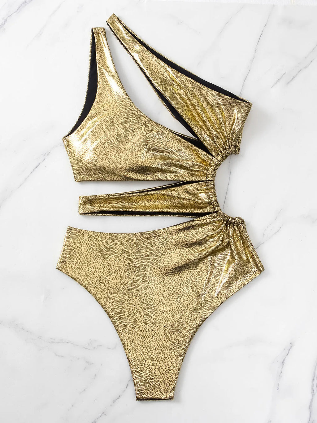 Gold one-piece backless swimsuit for women laid flat, showing sleeveless design.