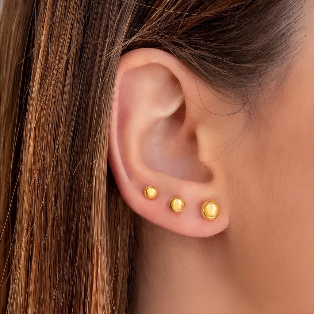 Stainless steel ball stud earrings in gold and silver tones, showing different sizes from 3mm to 6mm.