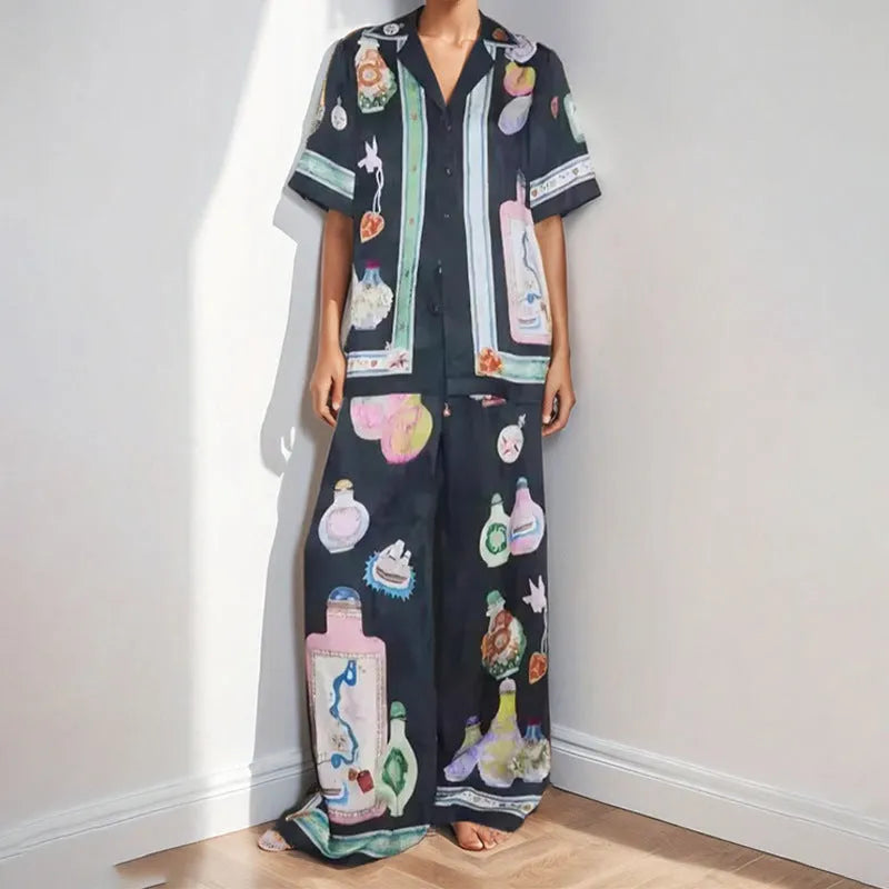 Black women's cardigan set with cartoon pattern, includes top with regular sleeves and matching trousers