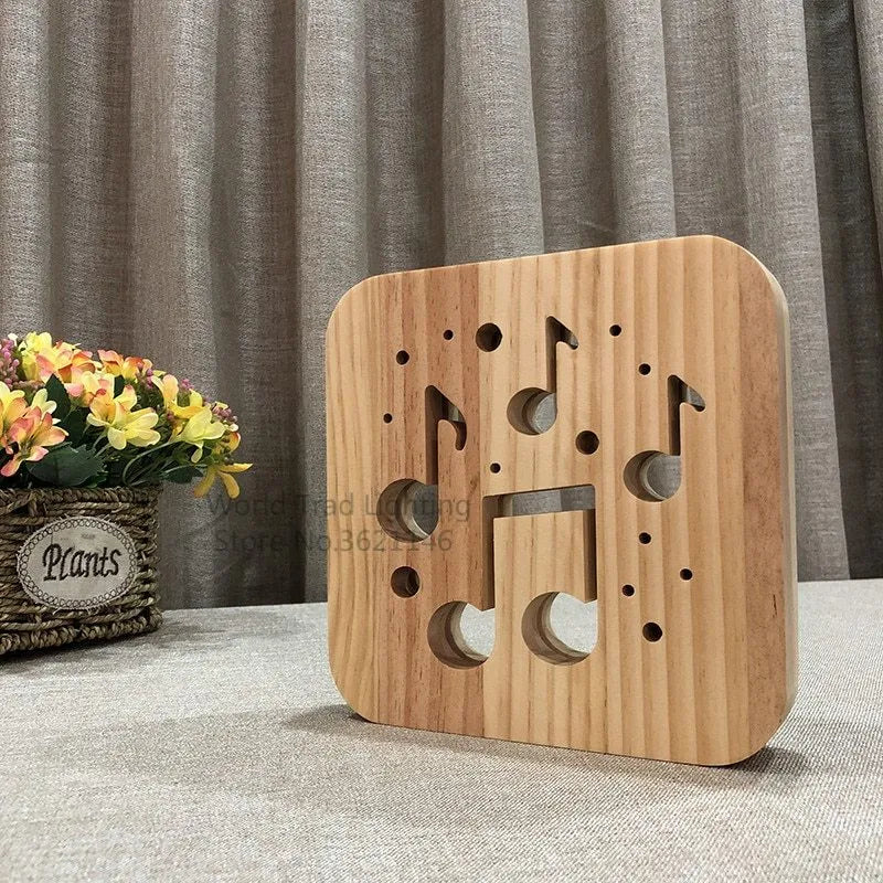 Square pine wood USB LED atmosphere lamp emitting warm white light, showing its 3D design and button switch.