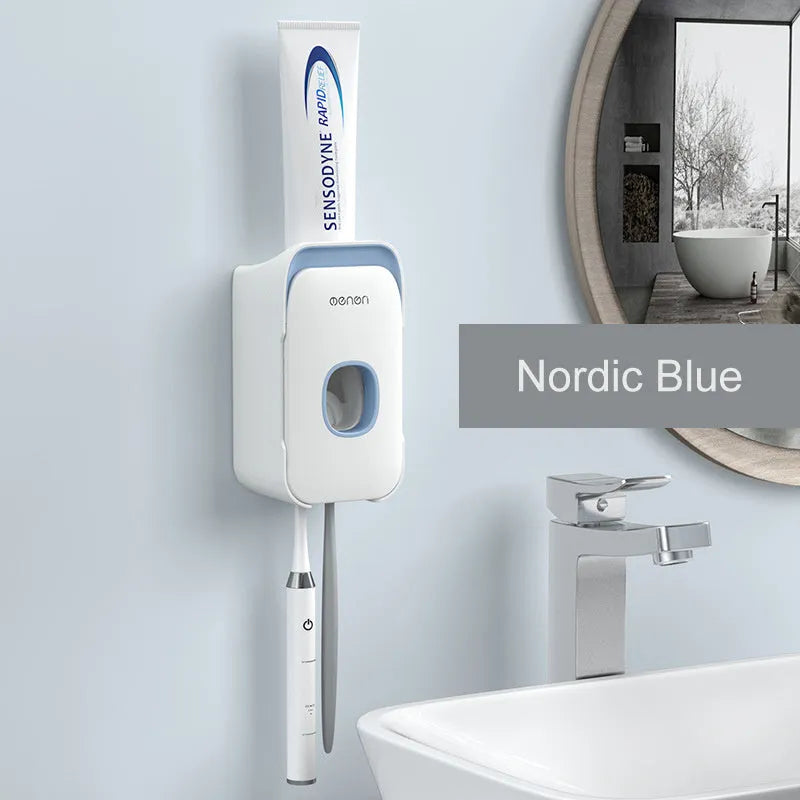 Blue automatic toothpaste dispenser with wall-mount bracket on a bathroom wall