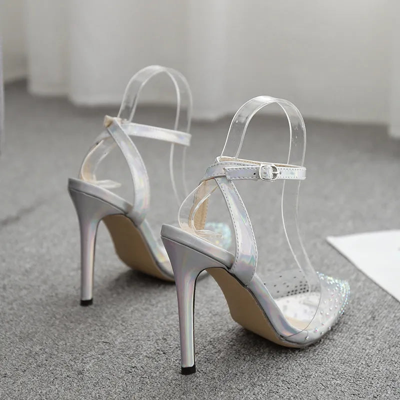 Women's pointed-toe stiletto sandals with a clear PVC upper.