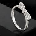 Silver bow ring with rhinestone crystals in couple style band design