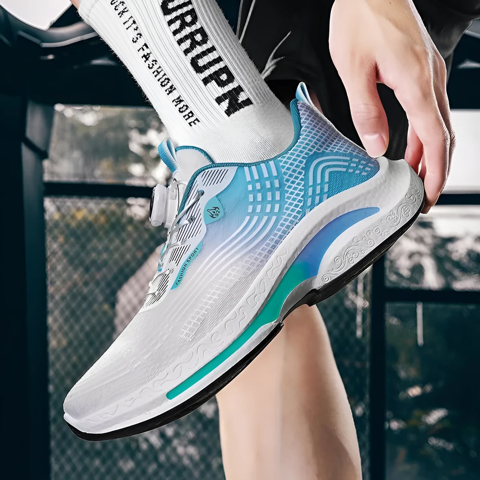 Men's low-top mesh sneakers in black and blue colourway with rubber sole.