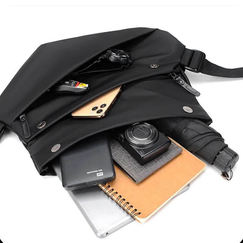 Grey medium crossbody bag with zipper opening showing internal phone and document compartments