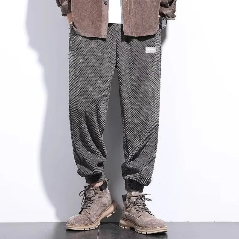 Men's grey straight-leg sweatpants with an adjustable ankle strap, laid flat.