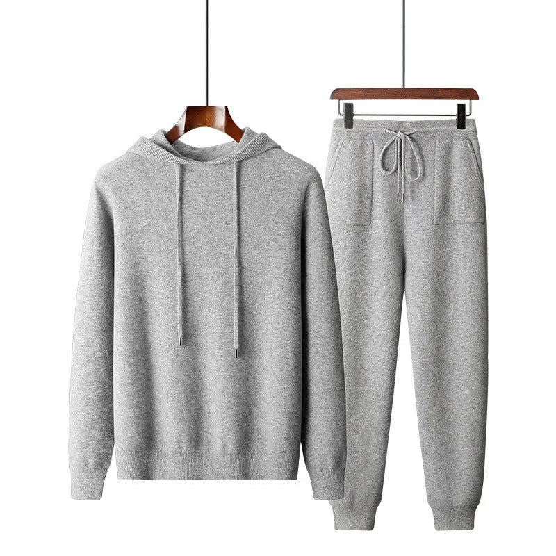Men's light grey hooded cashmere sweatshirt and matching trousers laid flat as a complete casual set.