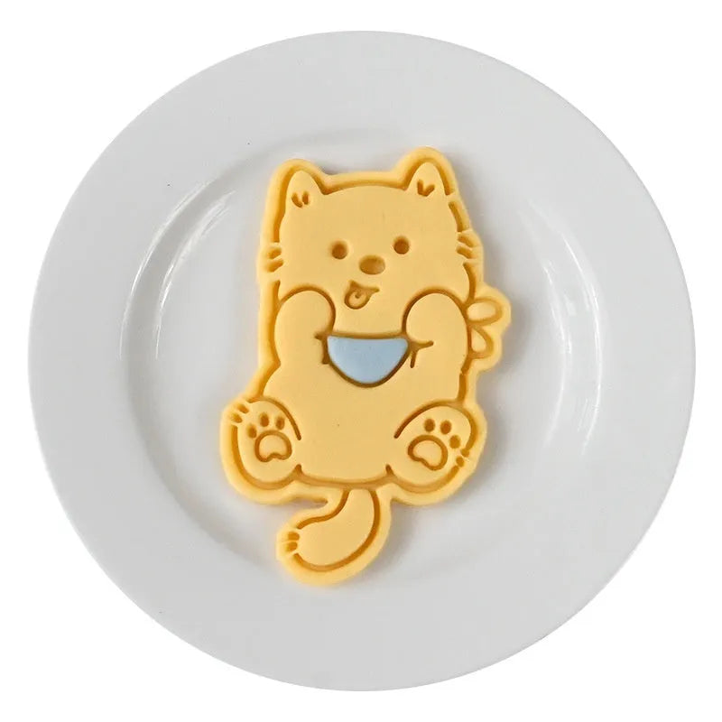 Three dimensional plastic biscuit mold with puppy cartoon designs including puppy head and birthday hat