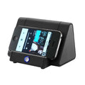 Black and white wireless mini Bluetooth speaker with charging cable.