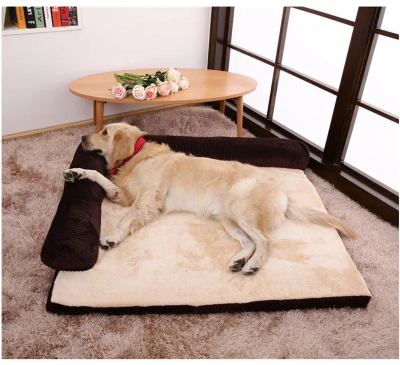 A corduroy dog sofa bed with raised sides, shown in a grey colour, placed on a wooden floor.