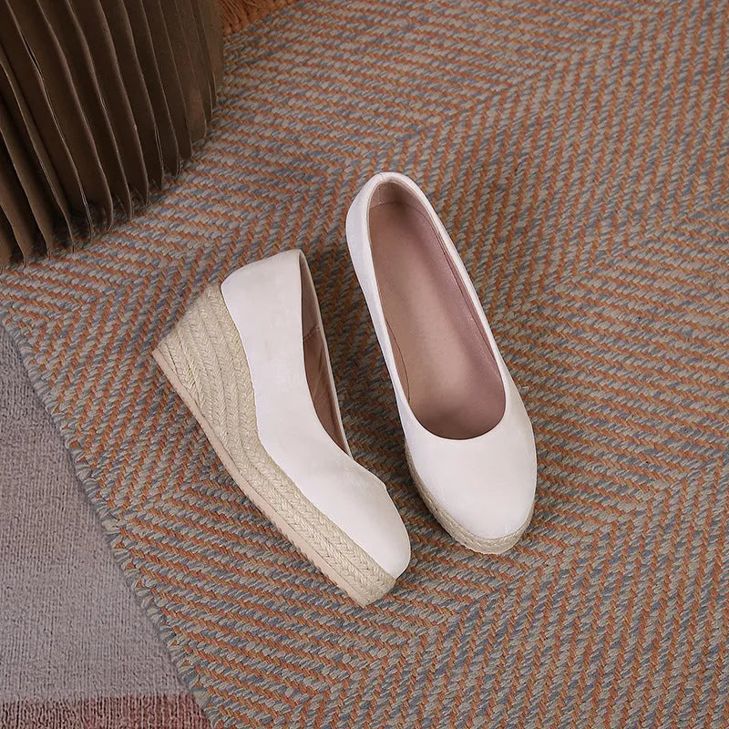 Women's wedge heel pumps with thick rope-bottom soles and shallow open-toe design