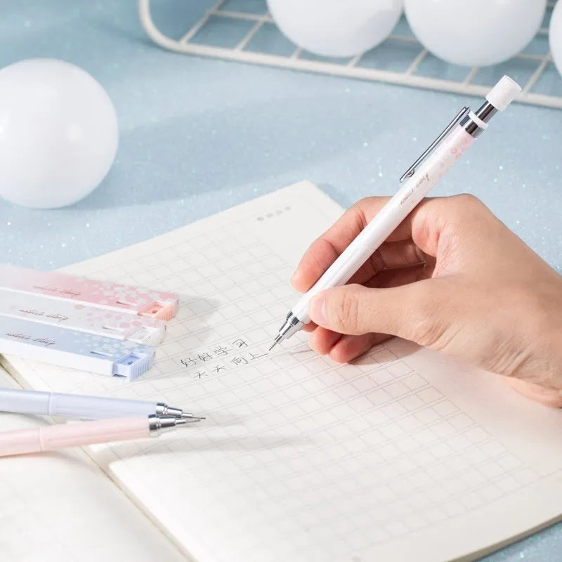 Set of three cartoon-design 0.5mm automatic pencils with boxes of HB refills.