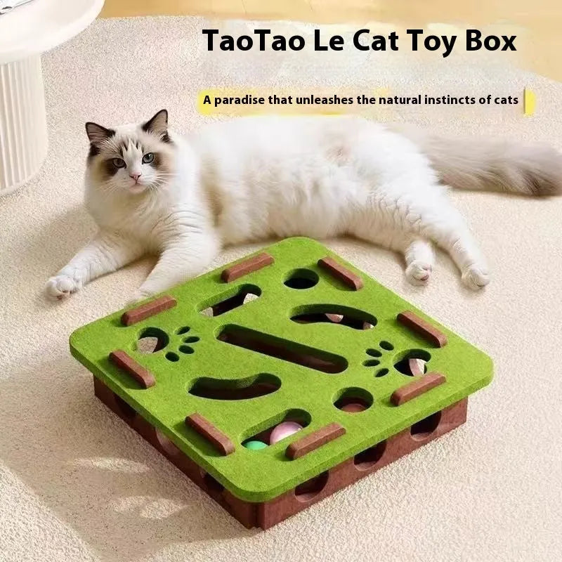 Rectangular green brown felt cat scratching box with holes, shown on a floor.
