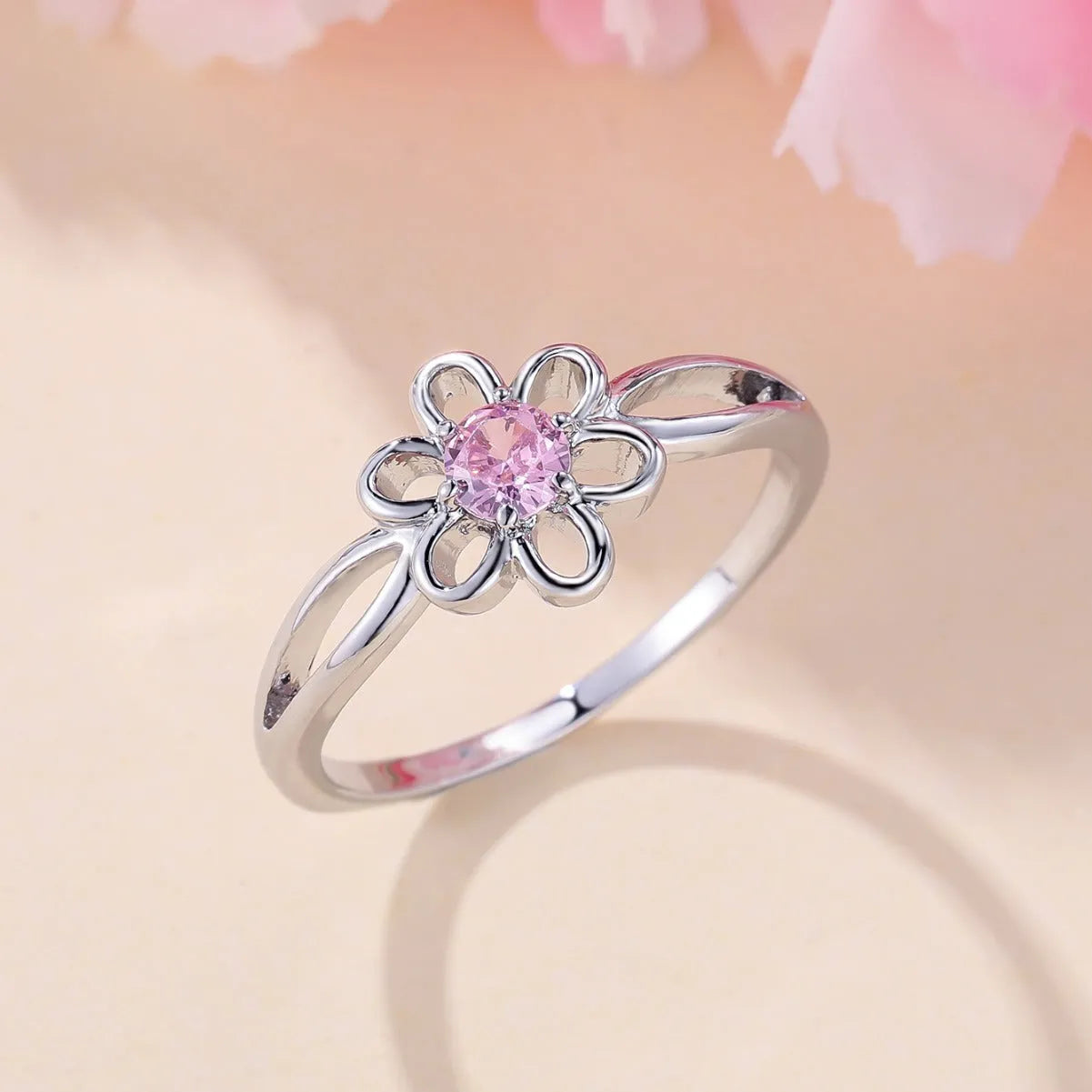 Women's flower-shaped hollow-out copper fashion ring in platinum pink diamond colour.