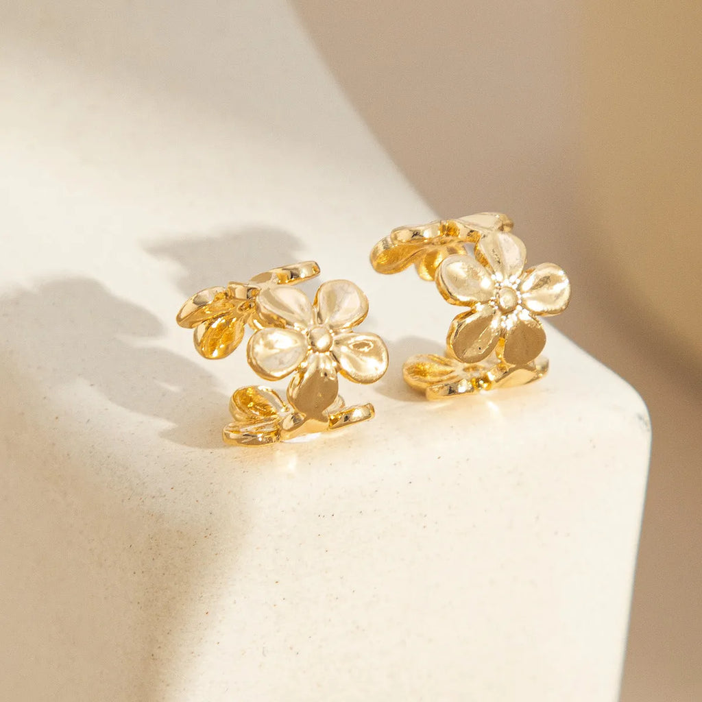 Gold starfish and conch shell earrings with electroplated finish and detailed coastal designs